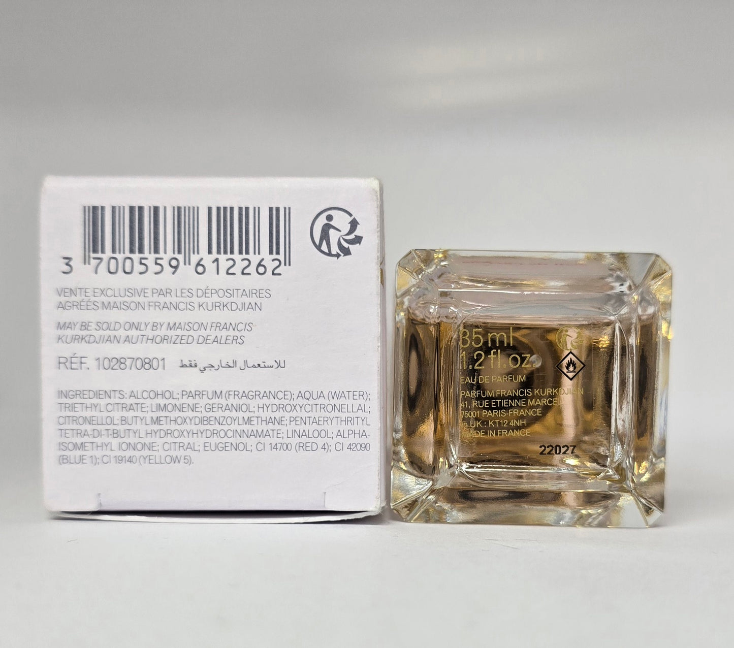 Square glass perfume bottle with its packaging on a white background