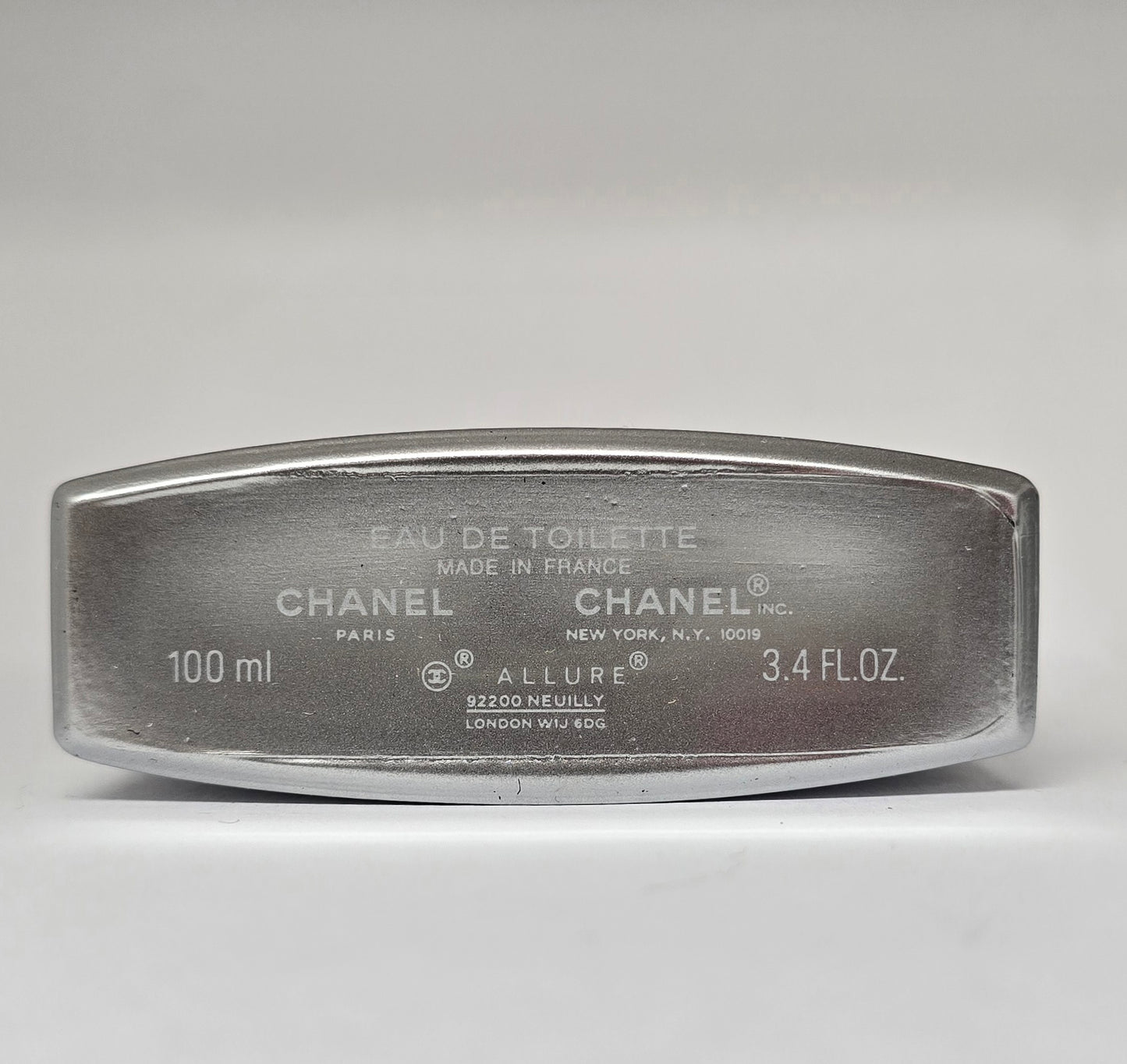 Chanel Allure Eau de Toilette container on a gray background