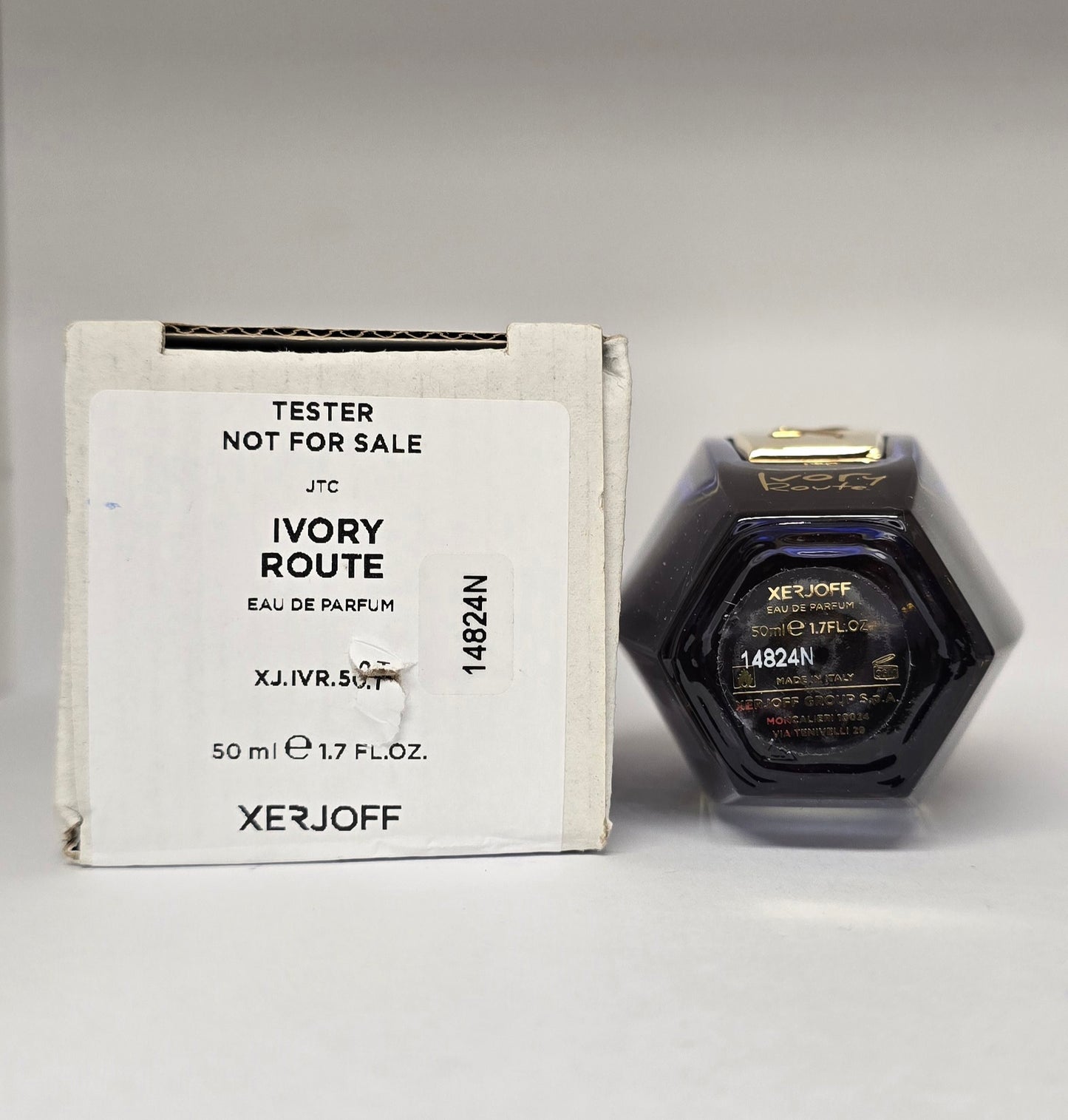 Xerjoff Ivory Route perfume bottle and packaging on a gray background