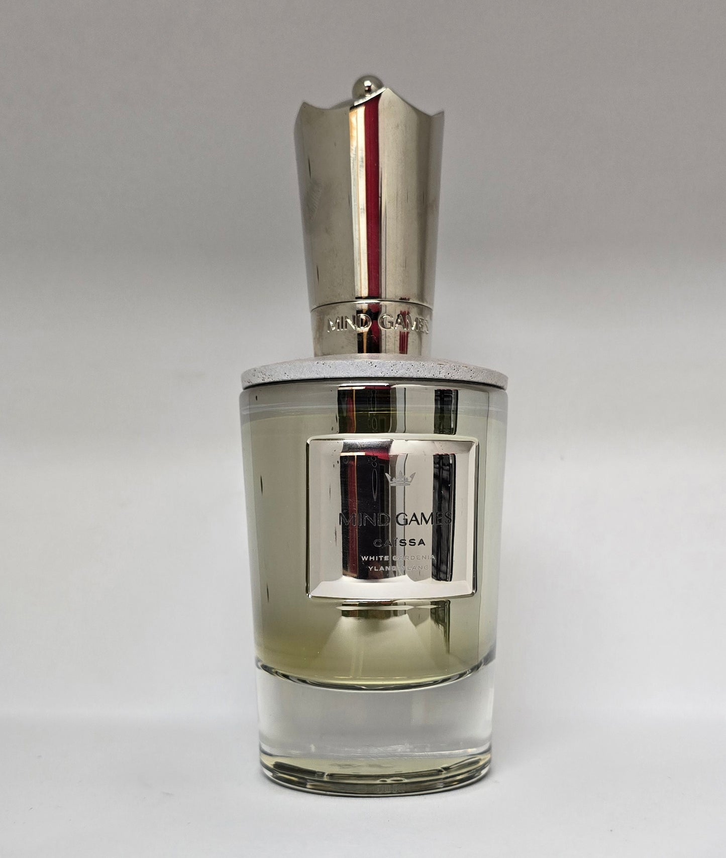Perfume bottle with silver cap on a gray background