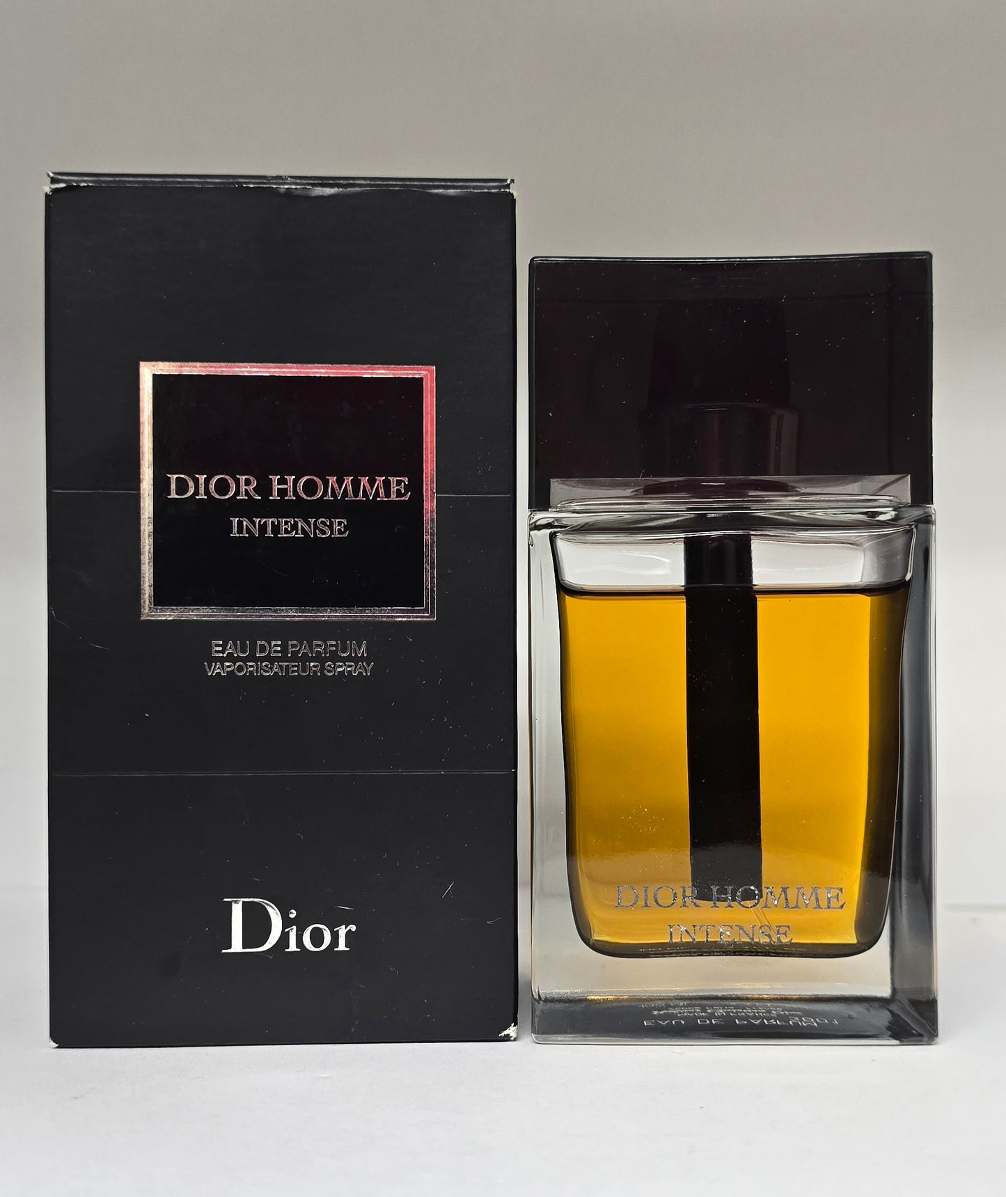 Dior Homme Intense perfume bottle and packaging on a white background
