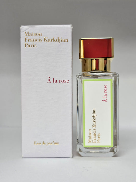Maison Francis Kurkdjian perfume bottle and packaging on a gray background