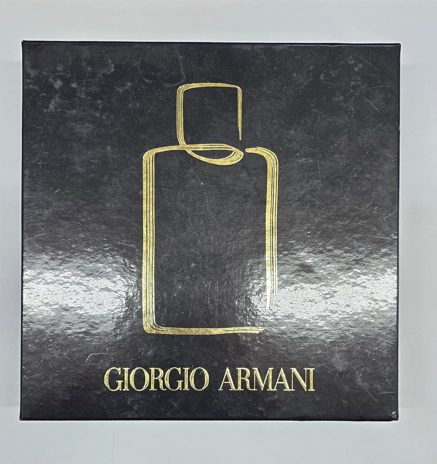 Giorgio Armani perfume bottle packaging on a black background