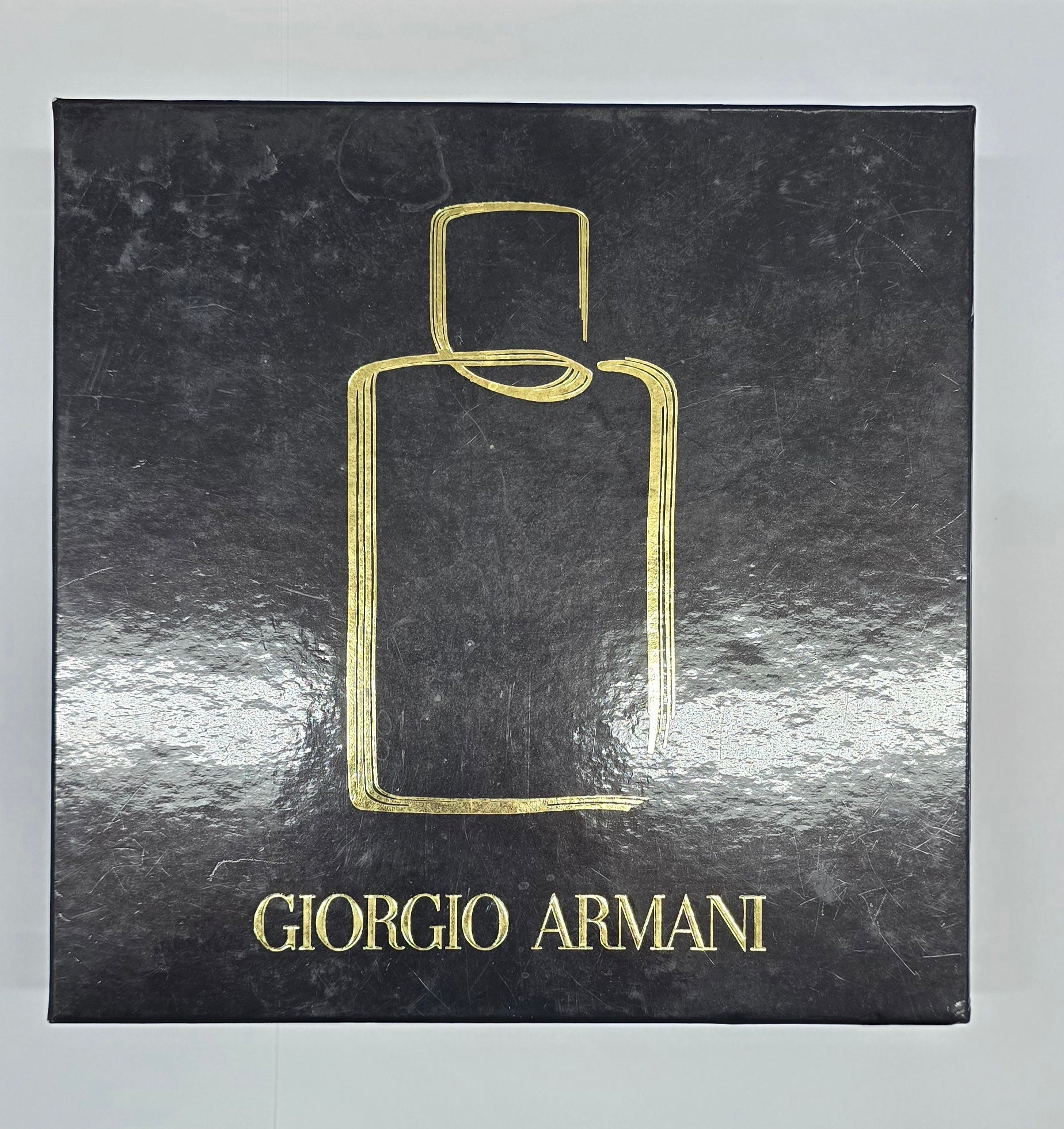 Giorgio Armani perfume bottle packaging on a black background