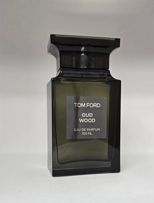 Tom Ford Oud Wood perfume bottle on a gray background