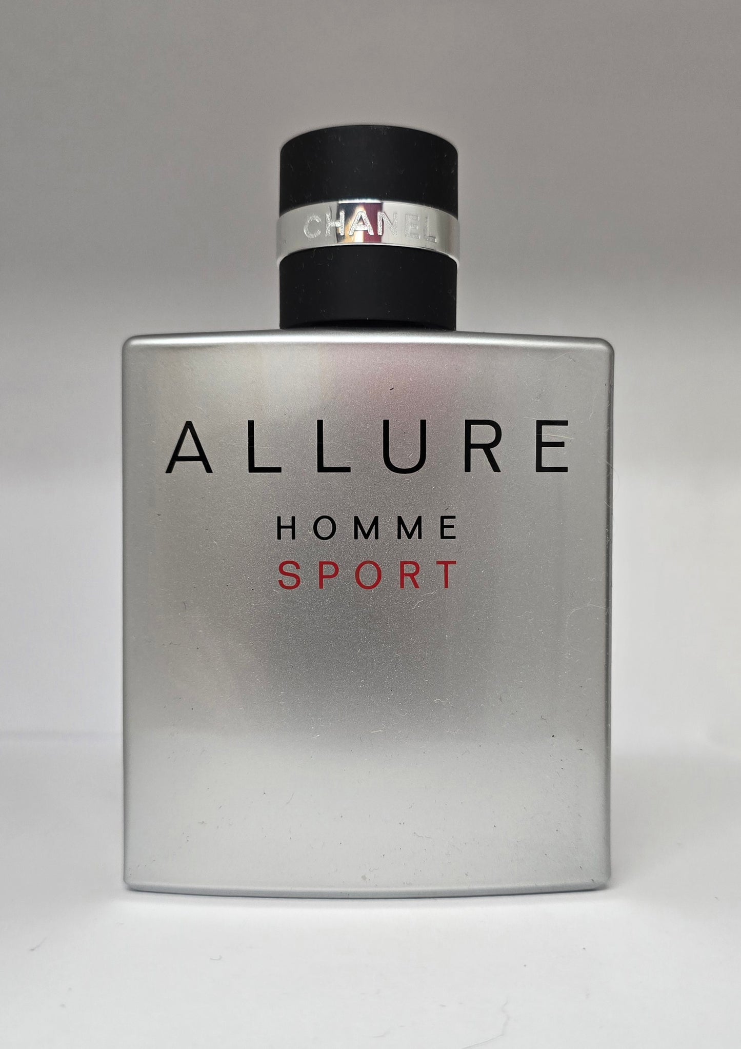 Chanel Allure Homme Sport perfume bottle on a gray background