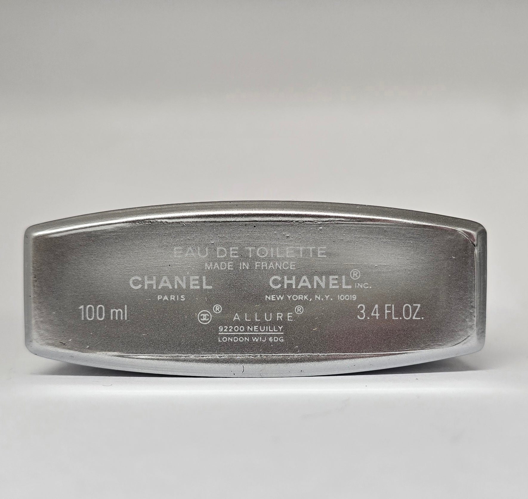 Chanel Allure Eau de Toilette container on a gray background