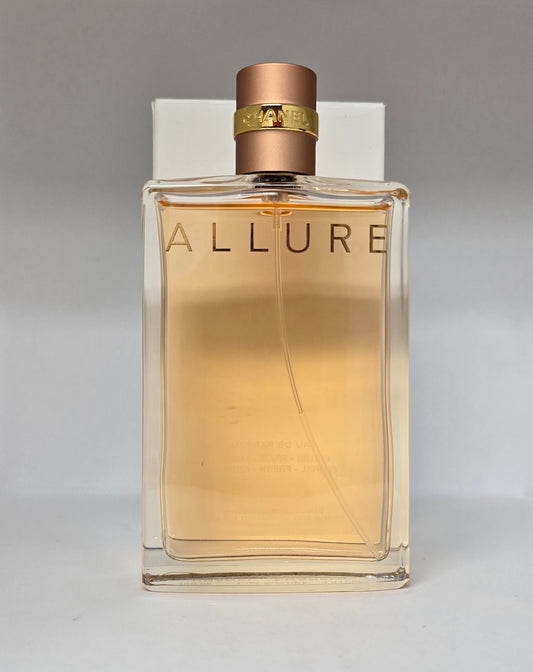 Perfume bottle labeled 'Allure' with a gold cap on a gray background