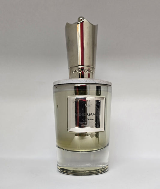 Perfume bottle with silver cap on a gray background