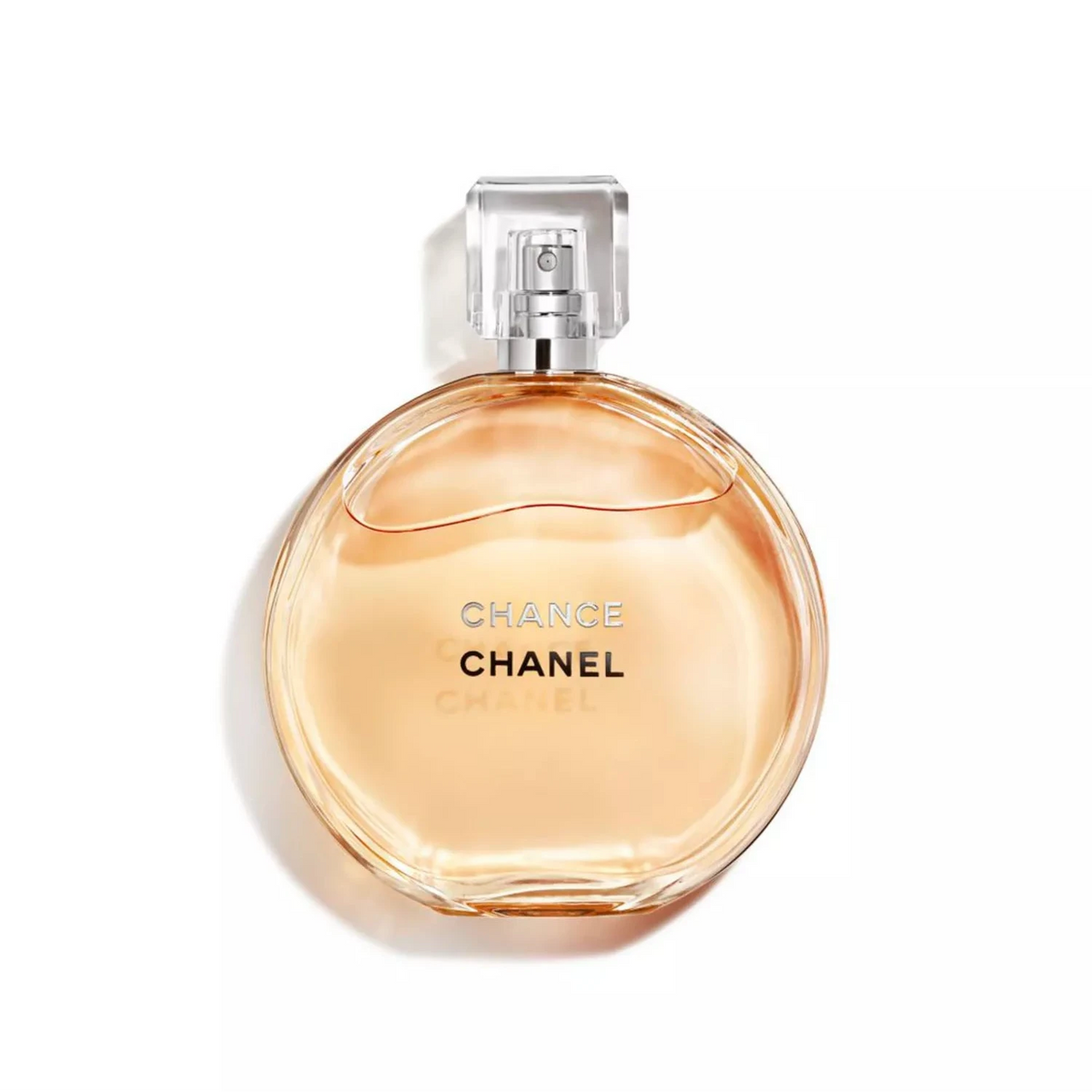 Chanel Chance Eau de Parfum bottle with a round, transparent peach-colored glass body and a clear cap, set against a plain white background.