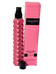 Pink perfume bottle and packaging with 'Valentino' branding on a white background