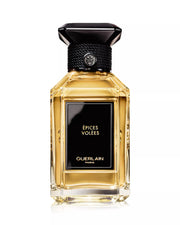 Guerlain perfume bottle with black cap on a white background