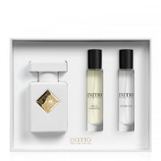 Initio Parfum Privés gift set containing a white perfume bottle with a gold diamond emblem, a 10ml musk therapy roll-on, and a 10ml flower silk roll-on, all in a white presentation box.